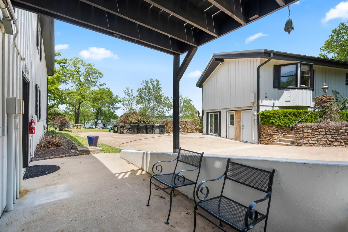 An inviting exterior area featuring benches set amid lush greenery and a building backdrop, suggesting opportunities for outdoor relaxation, socializing, and soaking in the natural environment.